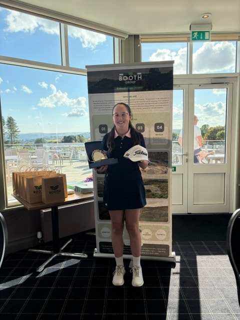 Junior golfer with trophy and Titleist prize