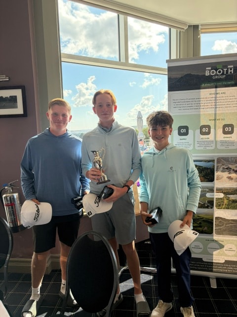 Team winners with trophy at the Booth Group stand